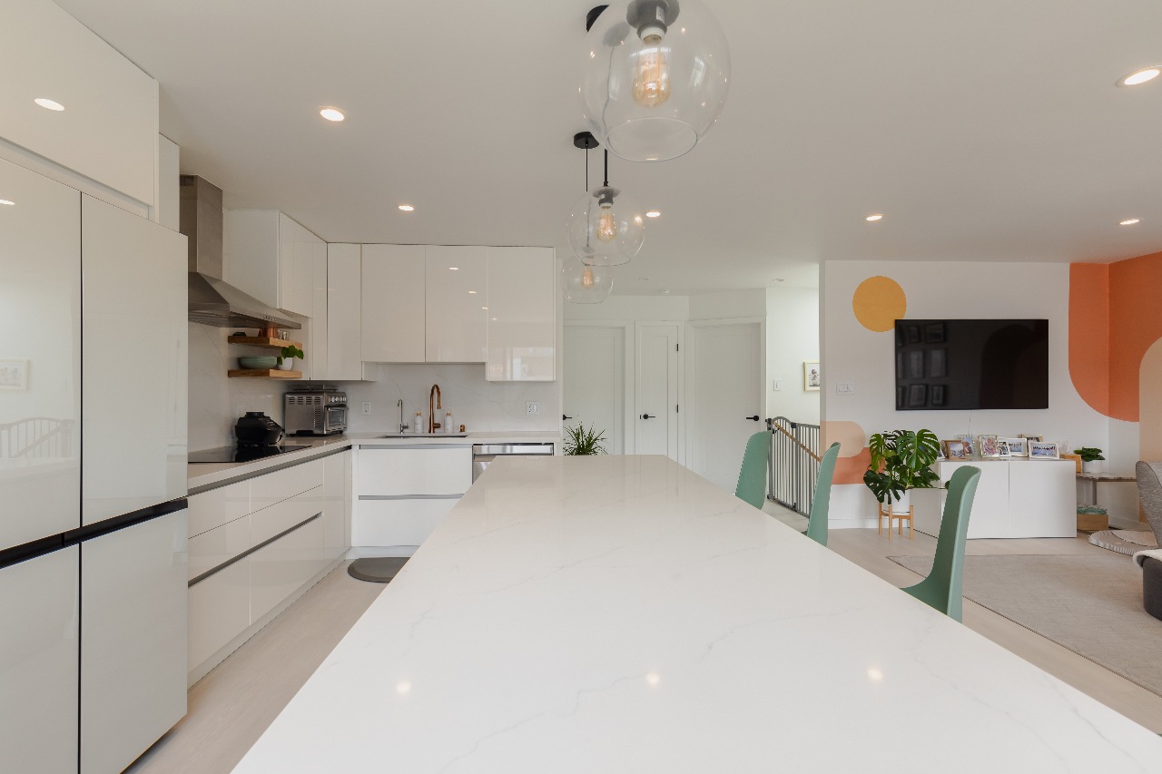 Kitchen with island and white cabinets in San Francisco full-house remodel