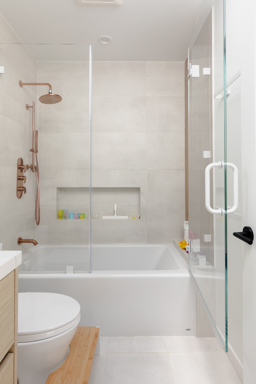Shower with copper fixtures and white tile in San Francisco full-house remodel