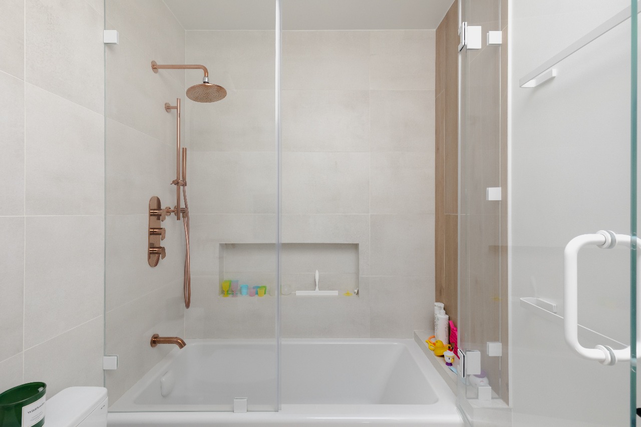 Shower with copper fixtures and tiled niche in San Francisco full-house remodel
