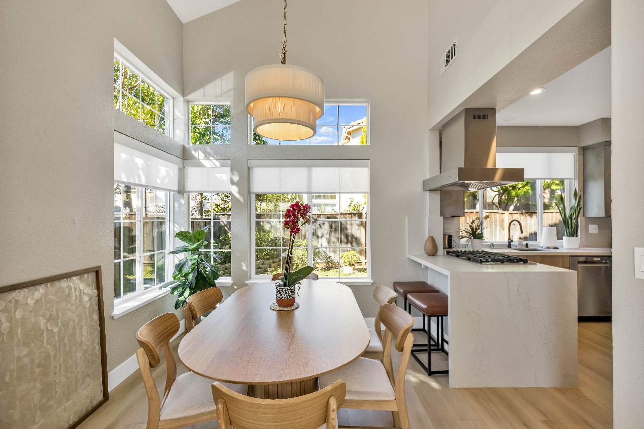 Kitchen and dining area with large windows and pendant light in Alameda full-house remodel