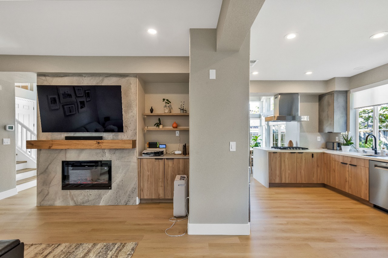 Living room with TV above fireplace in Alameda full-house remodel
