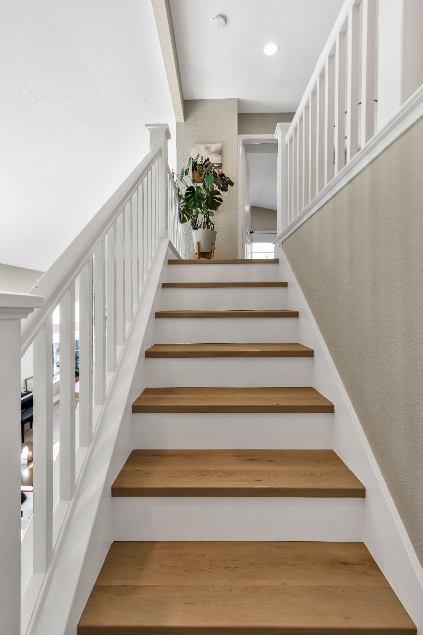 Staircase with white railings in Alameda full-house remodel