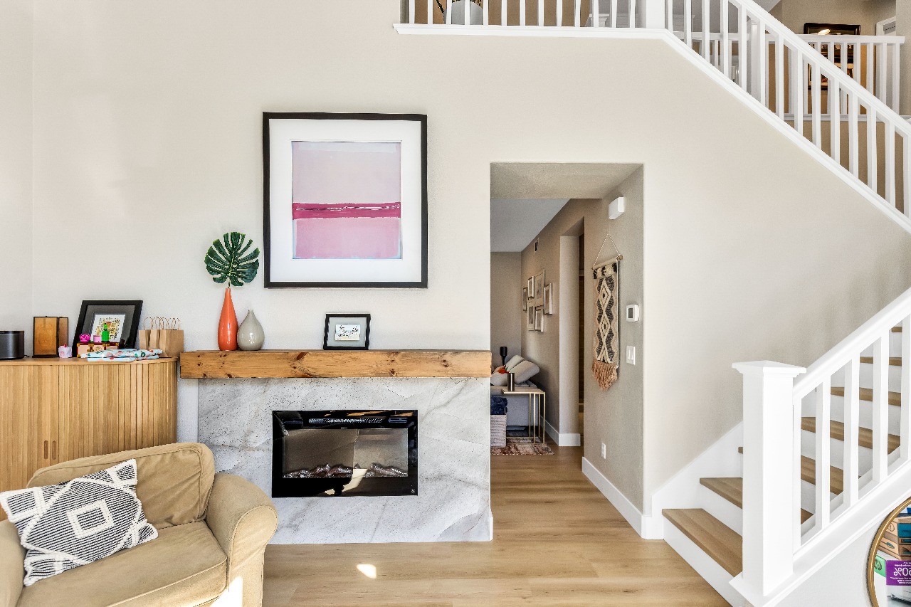 Living room with fireplace and wood mantel in Alameda full-house remodel