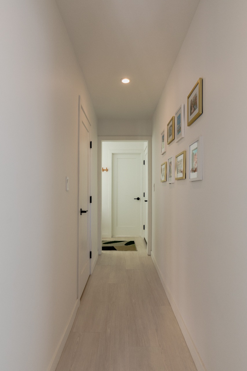 Hallway with framed photos in San Francisco full-house remodel