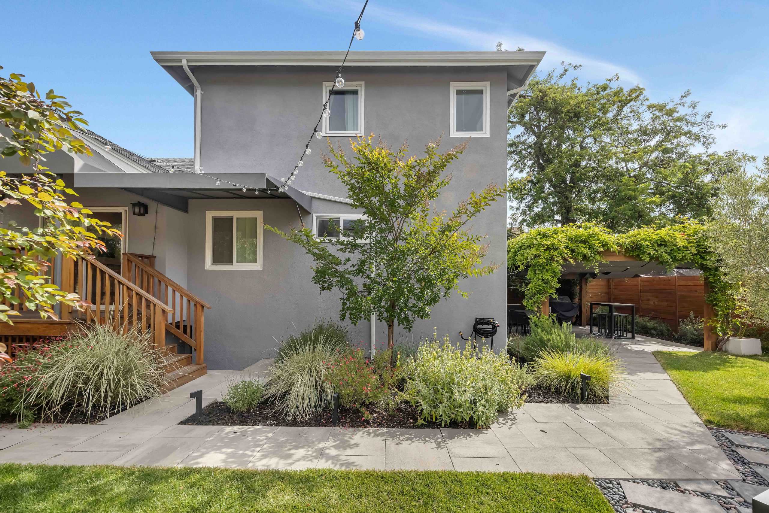 Recent home addition exterior with drought-smart landscaping by New Bay Builders
